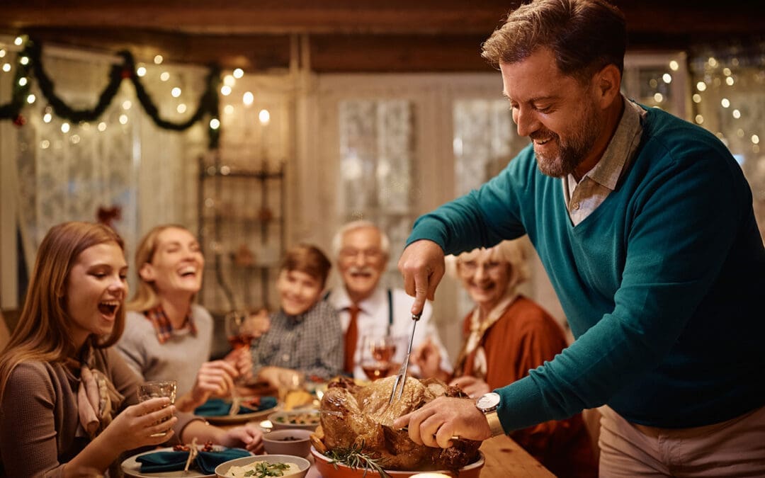 Thanksgiving Dinner with a family waiting on a Dad to carve the turkey.