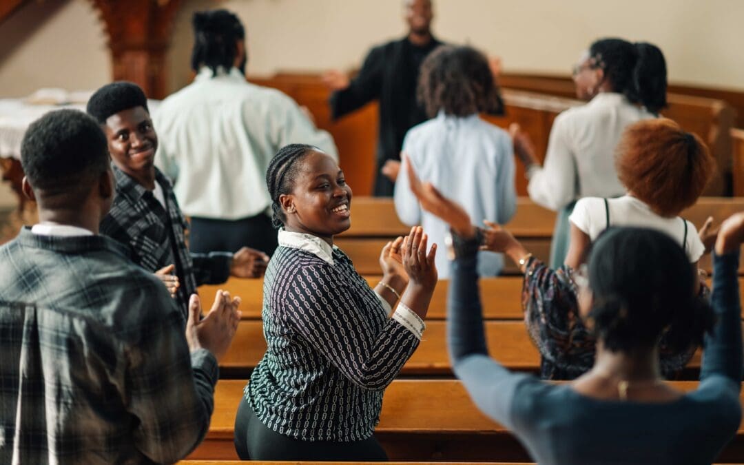 Diverse gospel choir joyfully sings and claps during a religious service led by a passionate priest in a traditional church, showcasing faith, spirituality, and unity