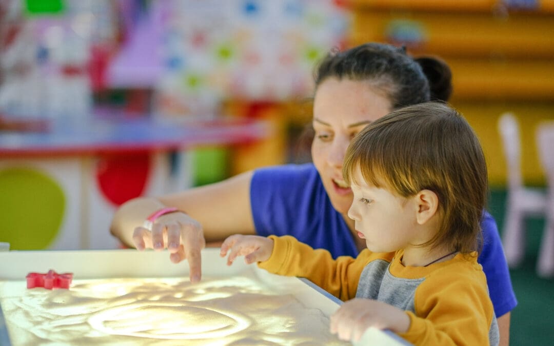 Woman and young child doing a sensory activity